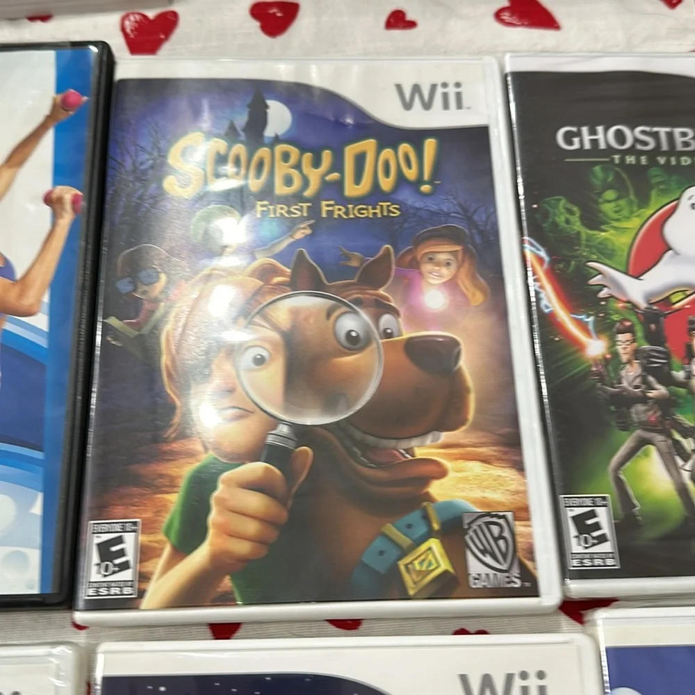 Nintendo Wii black w 2 remotes and 7 games.6 games in cases 1 has no case.